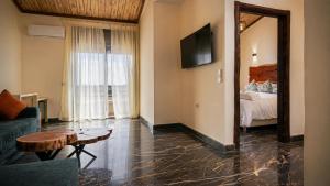 a living room with a couch and a table at Hotel Paradise KMA in Bouznika