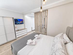 a bedroom with a large bed with two towels at Adriana Luxury Studio in Kastoria