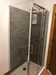 a shower with a glass enclosure in a bathroom at Our Wendy House in Holsworthy