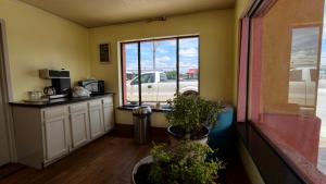 a room with a kitchen with a truck outside the window at Deluxe Inn By Capital O Odessa I-20 in Odessa