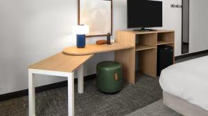 a bedroom with a desk with a computer and a bed at Spark By Hilton Owen Sound in Owen Sound