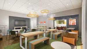 a dining room with tables and chairs and lights at Spark By Hilton Owen Sound in Owen Sound