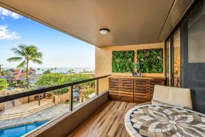 a balcony with a view of the ocean at Kona Pacific A306 in Kailua-Kona