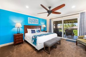 a bedroom with a bed and a ceiling fan at Halii Kai 20F in Waikoloa