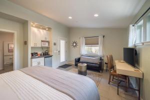 a bedroom with a bed and a desk and a kitchen at The Entrada Flat 1 in Moab UT in Moab
