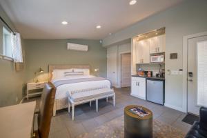 a bedroom with a large bed and a kitchen at The Entrada Flat 1 in Moab UT in Moab
