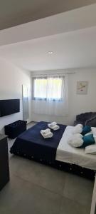 a bedroom with a large bed with towels on it at Les chambres de Dolce in Bandol +7 photos