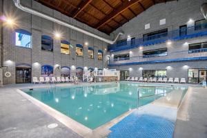 a large swimming pool with chairs in a building at Massanuttens Shenandoah Villas by TripForth in McGaheysville