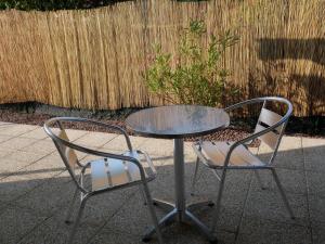 two chairs and a glass table and a table and chairs at Studios Saint Mau 4 in Saint-Maurice-de-Gourdans +3 photos