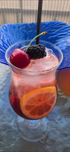 a drink with fruit in a glass bowl on a table at Mista apartment in Peyia