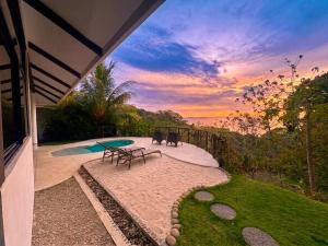 a view of a patio with a table and a pool at Akua Suites Ocean View in Tárcoles
