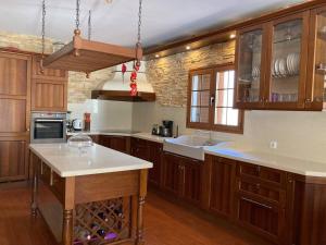 a kitchen with wooden cabinets and a white counter top at Villa Ingrid. Piscina exterior. in Las Playitas