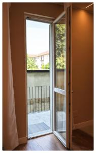 a sliding glass door with a view of a balcony at Adapartament in Vercelli