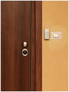 a wooden door with a remote control on it at Adapartament in Vercelli