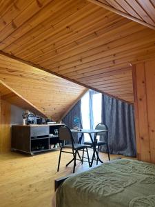 a room with a bed and a table and chairs at Shine Hill შაინ ჰილი in Tsinsvla