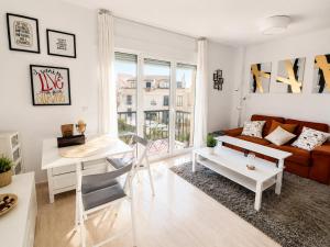a living room with a couch and a table at Dunas de Corrubedo in Ribeira +7 photos