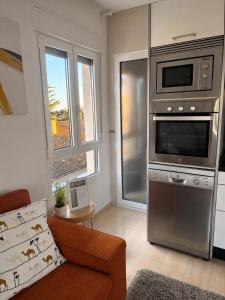 a living room with a stove and a microwave at Dunas de Corrubedo in Ribeira