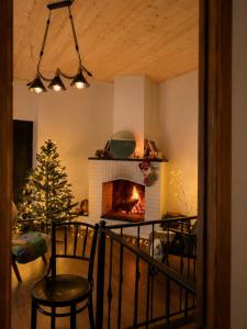 a living room with a fireplace and a christmas tree at The Fireplace ROOM in Borjomi