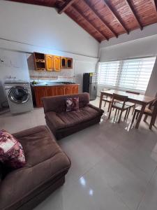 a large living room with a couch and a table at ApartaHotel Los Naranjos in Apartadó