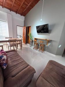 a living room with a couch and a table at ApartaHotel Los Naranjos in Apartadó