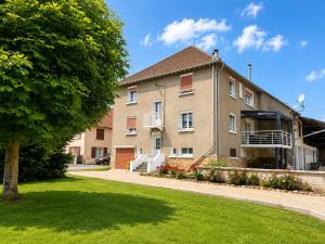 an apartment building with a tree in the foreground at Gite à la campagne 4 étoiles - 200m2 in Sailly