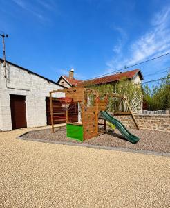 a playground with a slide and a basketball hoop at Gite à la campagne 4 étoiles - 200m2 in Sailly