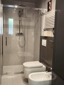 a bathroom with a shower and a toilet and a sink at L'Angolino Nascosto in Senigallia +16 photos
