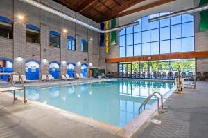 a large swimming pool with blue water in a building at Massanutten's Regal Vistas by TripForth in McGaheysville
