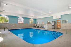a pool with blue water in a hotel room at Holiday Inn Express Deforest Madison Area by IHG in De Forest