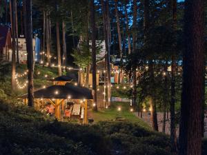 a garden at night with lights in the trees at Perła in Stegna