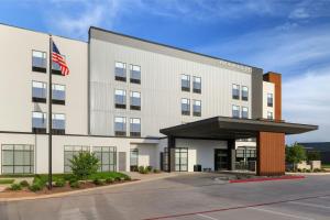 an office building with an american flag in front of it at SpringHill Suites by Marriott Abilene in Abilene