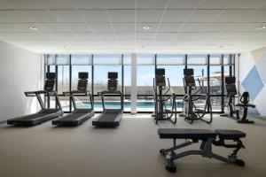 a gym with several treadmills and a swimming pool at SpringHill Suites by Marriott Abilene in Abilene