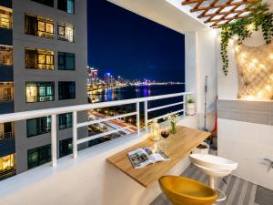 a balcony with a view of the city at night at Sea View Apartment Muong Thanh Oceanus Nha Trang in Nha Trang