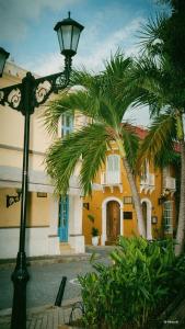 a street light in front of a building with palm trees at Casa Heredia Boutique in Cartagena de Indias