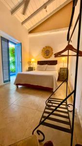 a bedroom with a bed and two tables and two lamps at Casa Heredia Boutique in Cartagena de Indias +30 photos
