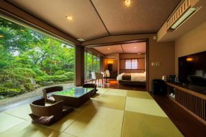a living room with a view of a bedroom at Okuyado Buaiso in Yufu