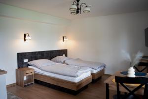 a bedroom with a bed and a table and lights at Agro Zahary in Miastko +48 photos