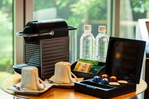 a table with a computer and bottles of water at Okuyado Buaiso in Yufu