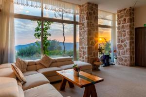 a living room with a couch and a table at Villa Panorama Kalkan Jilda Livya in Kalkan