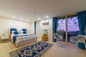 a bedroom with a king sized bed and a balcony at Villa Panorama Kalkan Jilda Livya in Kalkan +88 photos