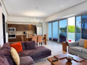 a living room with a couch and a table at ICON Oceanview Retreat by Monyxbnb in Puerto Vallarta