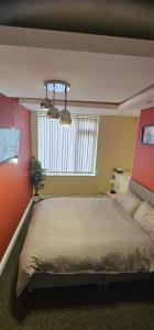 a bedroom with a large bed and a window at Sure stay property in Bolton