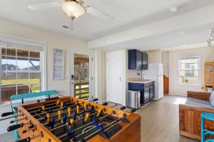 a living room with a ping pong table at 6150 - B Groove Inn (formerly Pelican Crest) in Nags Head