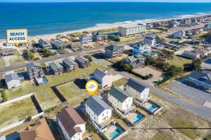an aerial view of a city with a beach access sign at 6150 - B Groove Inn (formerly Pelican Crest) in Nags Head