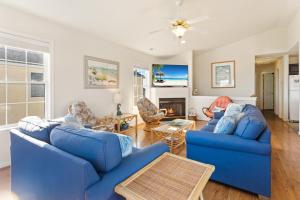 a living room with two blue couches at 6150 - B Groove Inn (formerly Pelican Crest) in Nags Head +60 photos