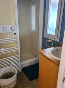 a bathroom with a sink and a shower and a toilet at Mobile Home in Morbier