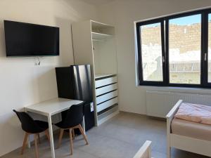a small room with a table and a refrigerator at Private Room in Hannover