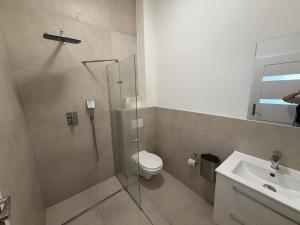 a bathroom with a shower and a toilet and a sink at Private Room in Hannover