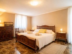 a bedroom with a large bed with two tables and a television at La Dimora Sulla Collina Micciani Rieti in Micciani