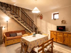 a living room with a table and a staircase at La Dimora Sulla Collina Micciani Rieti in Micciani